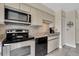 Modern kitchen featuring stainless steel appliances and a tile backsplash at 3601 East Bay Dr # 205, Holmes Beach, FL 34217