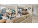 Open concept living space with comfortable sofa, dining space, kitchen and balcony access at 3601 East Bay Dr # 205, Holmes Beach, FL 34217