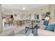 Spacious living room with open concept, kitchen bar, dining space, and comfortable seating at 3601 East Bay Dr # 205, Holmes Beach, FL 34217