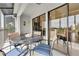 Comfortable screened patio with sliding glass doors, views to the kitchen and outdoor views at 3601 East Bay Dr # 205, Holmes Beach, FL 34217
