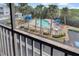 Elevated view of the outdoor community pool with fenced perimeter and lounge seating at 3601 East Bay Dr # 205, Holmes Beach, FL 34217
