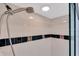 Shower with tiled walls, glass doors, and decorative tiled accents at 3601 East Bay Dr # 205, Holmes Beach, FL 34217