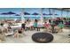 Beachside patio featuring ample seating, umbrellas, and beautiful ocean views for an enjoyable dining experience at 3780 Pinebrook Cir # 102, Bradenton, FL 34209