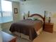 Comfortable bedroom with a plush queen bed, two lamps, and a pleasant view from the window at 3780 Pinebrook Cir # 102, Bradenton, FL 34209