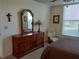 Bedroom features a beautiful wooden dresser with mirror and chair with a scenic view from the window at 3780 Pinebrook Cir # 102, Bradenton, FL 34209