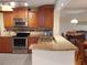 Stylish kitchen featuring granite countertops, stainless steel appliances, and updated wood cabinetry at 3780 Pinebrook Cir # 102, Bradenton, FL 34209