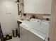A well lit laundry room with washer, dryer and storage at 3780 Pinebrook Cir # 102, Bradenton, FL 34209