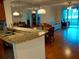 Open concept living area features a breakfast bar, dining area, and sliding glass doors to the patio at 3780 Pinebrook Cir # 102, Bradenton, FL 34209