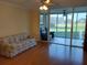 Living room featuring hardwood floors and sliding glass doors at 3780 Pinebrook Cir # 102, Bradenton, FL 34209