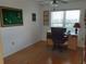 This office includes a ceiling fan and built-in desk with natural light from the window at 3780 Pinebrook Cir # 102, Bradenton, FL 34209