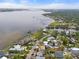 Stunning aerial view of waterfront property with lush landscaping, pool, and breathtaking water views at 4109 Riverview Blvd, Bradenton, FL 34209