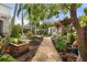 Beautiful backyard featuring lush greenery, a gravel path, and an outdoor sitting area at 4109 Riverview Blvd, Bradenton, FL 34209