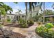 Beautiful backyard with brick pavers, lush landscaping, a garden, and an outdoor seating area at 4109 Riverview Blvd, Bradenton, FL 34209