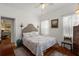 Cozy bedroom with wood floors, ceiling fan, queen bed, and neutral decor at 4109 Riverview Blvd, Bradenton, FL 34209