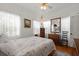Bright bedroom with hardwood floors, ceiling fan, decorative painting, and abundant natural light at 4109 Riverview Blvd, Bradenton, FL 34209