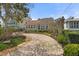 Charming home with a curved driveway, beautiful landscaping, and architectural details at 4109 Riverview Blvd, Bradenton, FL 34209