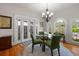 Charming dining room with hardwood floors, round table, and bright windows at 4109 Riverview Blvd, Bradenton, FL 34209