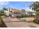 Charming house with a curved driveway, beautiful landscaping, and a welcoming front porch at 4109 Riverview Blvd, Bradenton, FL 34209