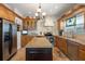 Well-lit kitchen featuring an island, stainless steel appliances, and custom wood cabinetry at 4109 Riverview Blvd, Bradenton, FL 34209