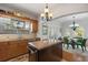 Bright kitchen featuring an island with seating, stainless steel sink, and view into the dining room at 4109 Riverview Blvd, Bradenton, FL 34209