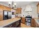 Kitchen featuring stainless steel appliances, a center island, tile backsplash and wood cabinets at 4109 Riverview Blvd, Bradenton, FL 34209