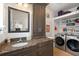 Functional laundry room with granite countertop, cabinetry, washer, and dryer at 4109 Riverview Blvd, Bradenton, FL 34209