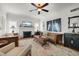Bright living room boasts a fireplace, hardwood floors, and an elegant ceiling fan at 4109 Riverview Blvd, Bradenton, FL 34209