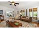 Comfortable living room with hardwood floors and decorative rug, with a view into the dining area at 4109 Riverview Blvd, Bradenton, FL 34209