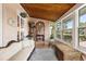 Cozy sun room with wood ceilings, lots of windows, and comfortable seating at 4109 Riverview Blvd, Bradenton, FL 34209