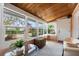 Cozy sun room with wood ceilings, lots of windows, and comfortable seating at 4109 Riverview Blvd, Bradenton, FL 34209