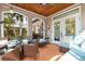 Inviting sunroom featuring wicker furniture, terra cotta tile floors and a wood plank ceiling with fan at 4109 Riverview Blvd, Bradenton, FL 34209