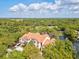 Aerial view of a pond with fountain next to lush landscaping and red roofs in a neighborhood community at 4178 Central Sarasota Pkwy # 325, Sarasota, FL 34238