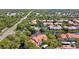Aerial view showcasing the community buildings, swimming pool, tennis court, and mature landscaping around the property at 4178 Central Sarasota Pkwy # 325, Sarasota, FL 34238