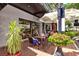Outdoor seating at ofKors Bakery, with lush plants and a welcoming awning at 4178 Central Sarasota Pkwy # 325, Sarasota, FL 34238