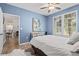 Charming bedroom with bright blue walls, a large window, and easy access to the dining area and other living spaces at 4178 Central Sarasota Pkwy # 325, Sarasota, FL 34238