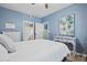 Cozy bedroom with soothing blue walls, white furniture, and an en-suite bathroom, creating a relaxing private space at 4178 Central Sarasota Pkwy # 325, Sarasota, FL 34238
