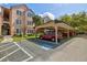 Handicap parking view of covered carport parking and the condo building at 4178 Central Sarasota Pkwy # 325, Sarasota, FL 34238
