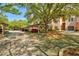 View of covered carport parking for residents with mature shade trees and manicured landscaping at 4178 Central Sarasota Pkwy # 325, Sarasota, FL 34238