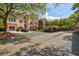 Condominium exterior showing parking, lush landscaping, and peach two-story buildings on a sunny day at 4178 Central Sarasota Pkwy # 325, Sarasota, FL 34238