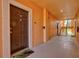 Hallway to residences with a dark wooden door and stairs in the background at 4178 Central Sarasota Pkwy # 325, Sarasota, FL 34238