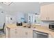Well-lit kitchen featuring stainless steel appliances, wood cabinets, and a breakfast bar area, open to the living space at 4178 Central Sarasota Pkwy # 325, Sarasota, FL 34238