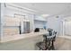 Kitchen with a breakfast bar, stainless steel appliances, light wood cabinets, and modern pendant lighting at 4178 Central Sarasota Pkwy # 325, Sarasota, FL 34238