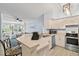 Open kitchen with breakfast bar seating that connects to the sunlit living area, creating an inviting and spacious feel at 4178 Central Sarasota Pkwy # 325, Sarasota, FL 34238