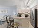 Kitchen featuring a breakfast bar with seating, stainless steel appliances, and seamless transition to the living area at 4178 Central Sarasota Pkwy # 325, Sarasota, FL 34238