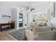 Spacious living room with comfortable seating, a wall-mounted TV, and natural light at 4178 Central Sarasota Pkwy # 325, Sarasota, FL 34238