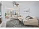 Sunlit living room featuring a large sectional sofa, neutral decor, and a view to the outdoor area at 4178 Central Sarasota Pkwy # 325, Sarasota, FL 34238