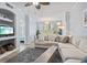 Bright living room featuring a neutral color palette, comfortable sofa, and a view of the dining area at 4178 Central Sarasota Pkwy # 325, Sarasota, FL 34238