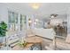 Bright living room featuring neutral furnishings, layered coffee tables, and a large window offering ample natural light at 4178 Central Sarasota Pkwy # 325, Sarasota, FL 34238