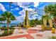 Beautiful view of a waterfront park entrance adorned with decorative arches and colorful landscaping at 4178 Central Sarasota Pkwy # 325, Sarasota, FL 34238