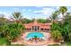 Resort-style community pool with palm trees, lounge chairs, and a sun-drenched lounging area at 4178 Central Sarasota Pkwy # 325, Sarasota, FL 34238